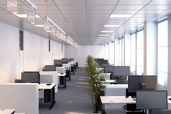 Open plan office with suspended lighting and workstations
